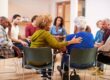 Caregiver support group sitting in a circle offering comfort