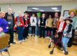 Seniors and staff in Halloween costumes at adult day services center