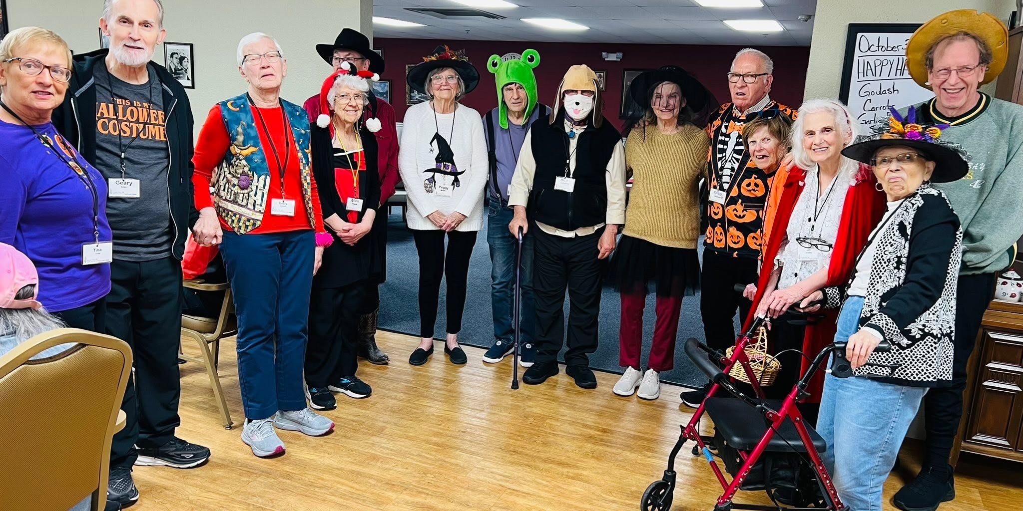 seniors-halloween-costume-party-adult-day-center Seniors and staff in Halloween costumes at adult day services center